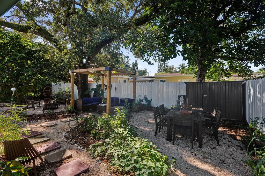 220 Northeast 165th Street Miami, FL 33162 - Photo 20 of 26 an outdoor space with patio and wooden fence