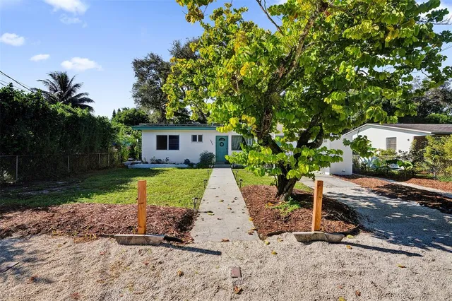 a view of a house with backyard porch and sitting area