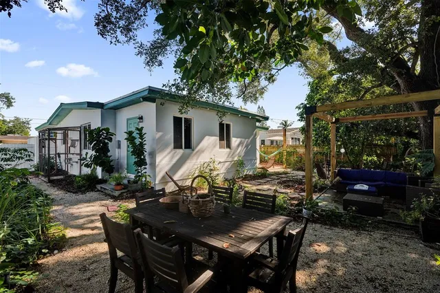 a backyard of a house with yard barbeque oven and outdoor seating
