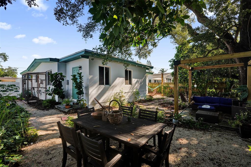 220 Northeast 165th Street Miami, FL 33162 - Photo 23 of 26 a view of a house with backyard and sitting area