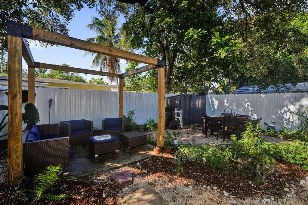 220 Northeast 165th Street Miami, FL 33162 - Photo 24 of 26 a backyard of a house with yard barbeque oven and outdoor seating