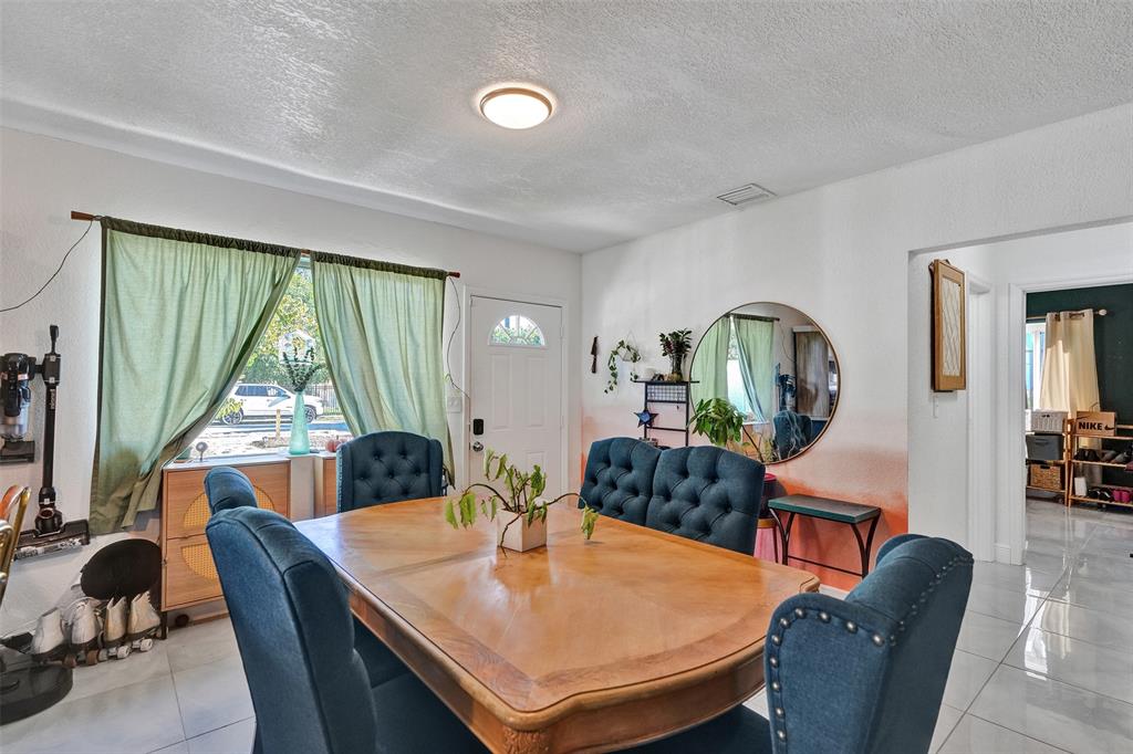 220 Northeast 165th Street Miami, FL 33162 - Photo 3 of 26 a living room with furniture and a large window