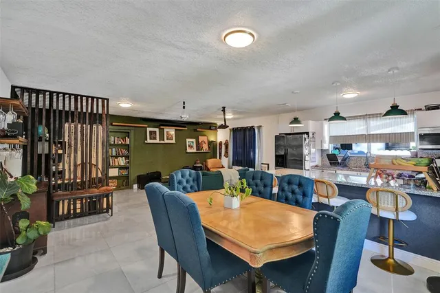 a dining room with furniture and wooden floor