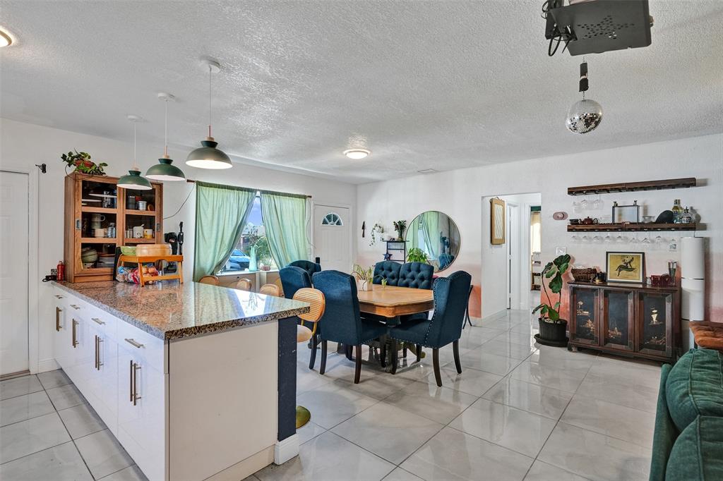 220 Northeast 165th Street Miami, FL 33162 - Photo 5 of 26 a room with furniture a air conditioner and a rug