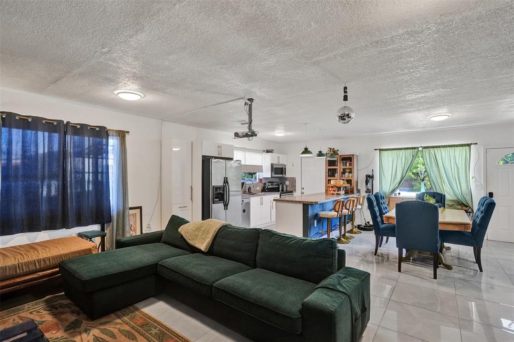 220 Northeast 165th Street Miami, FL 33162 - Photo 8 of 26 a living room with furniture and a large window