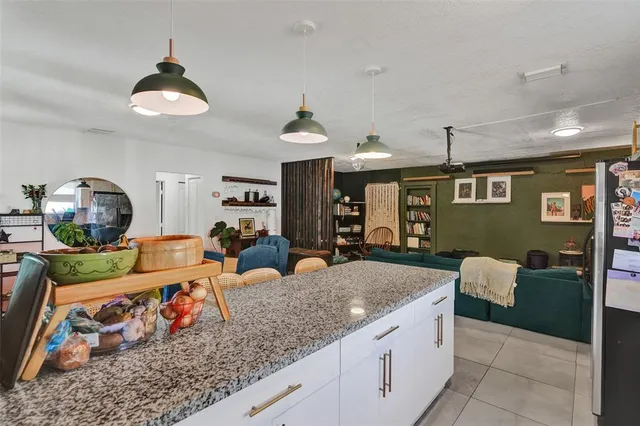 a kitchen with stainless steel appliances granite countertop a sink counter space cabinets and a window