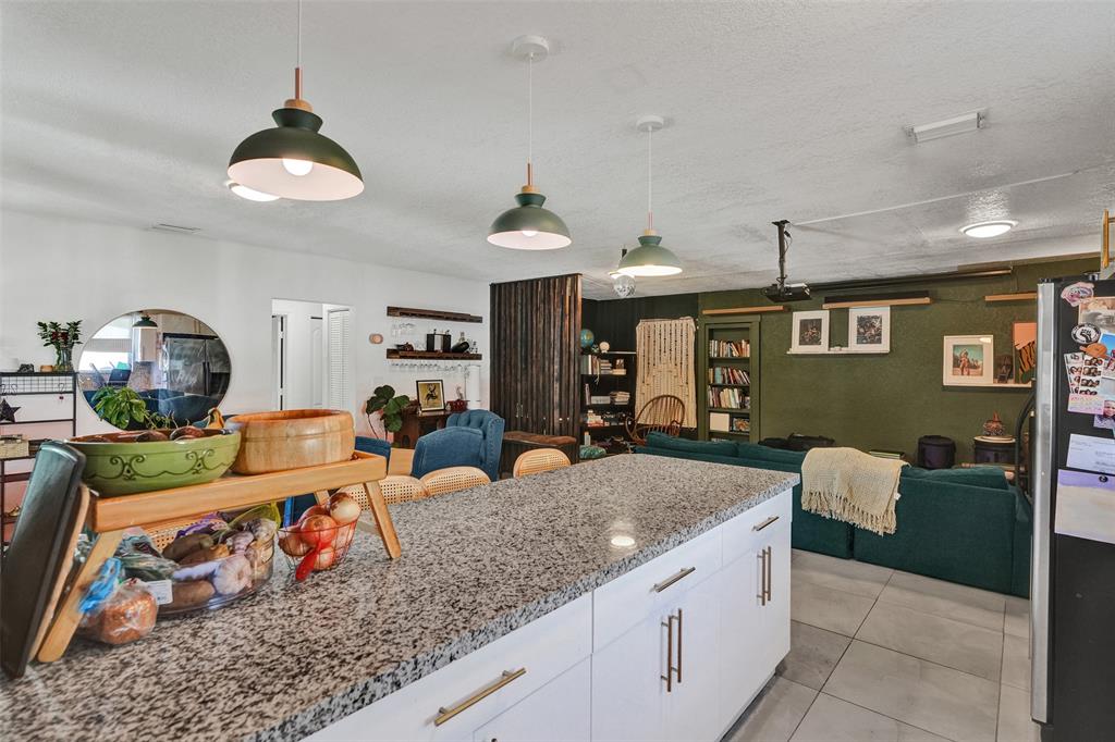 220 Northeast 165th Street Miami, FL 33162 - Photo 9 of 26 a kitchen with stainless steel appliances granite countertop a sink counter space cabinets and a window