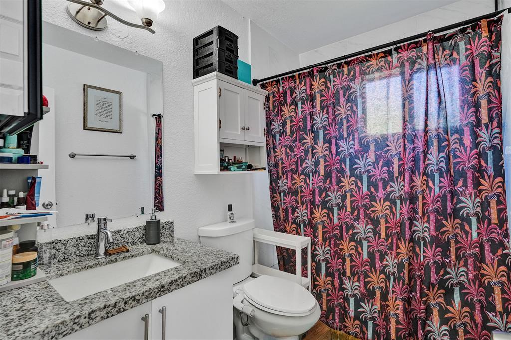 220 Northeast 165th Street Miami, FL 33162 - Photo 10 of 26 a bathroom with a granite countertop sink and a mirror
