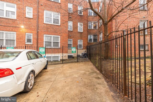 a view of a brick building with many windows