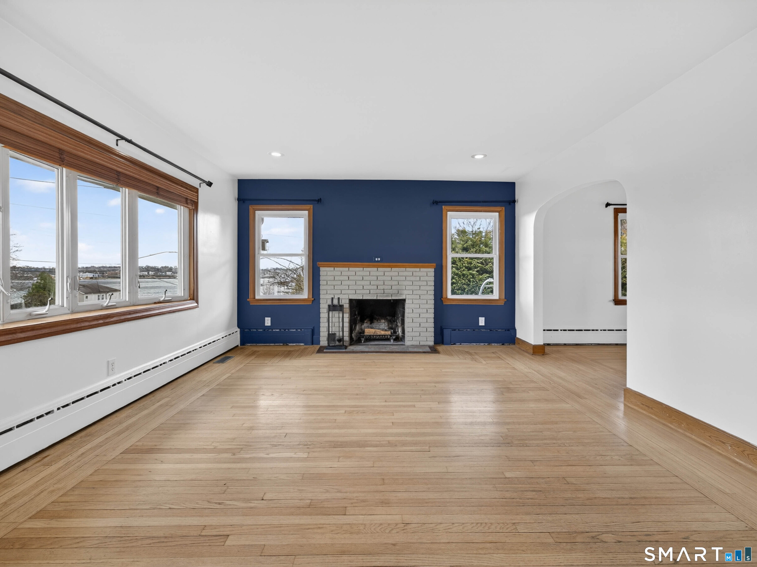 36 Baker Avenue Groton, CT 06340 - Photo 11 of 38 a view of an empty room with a fireplace and a window