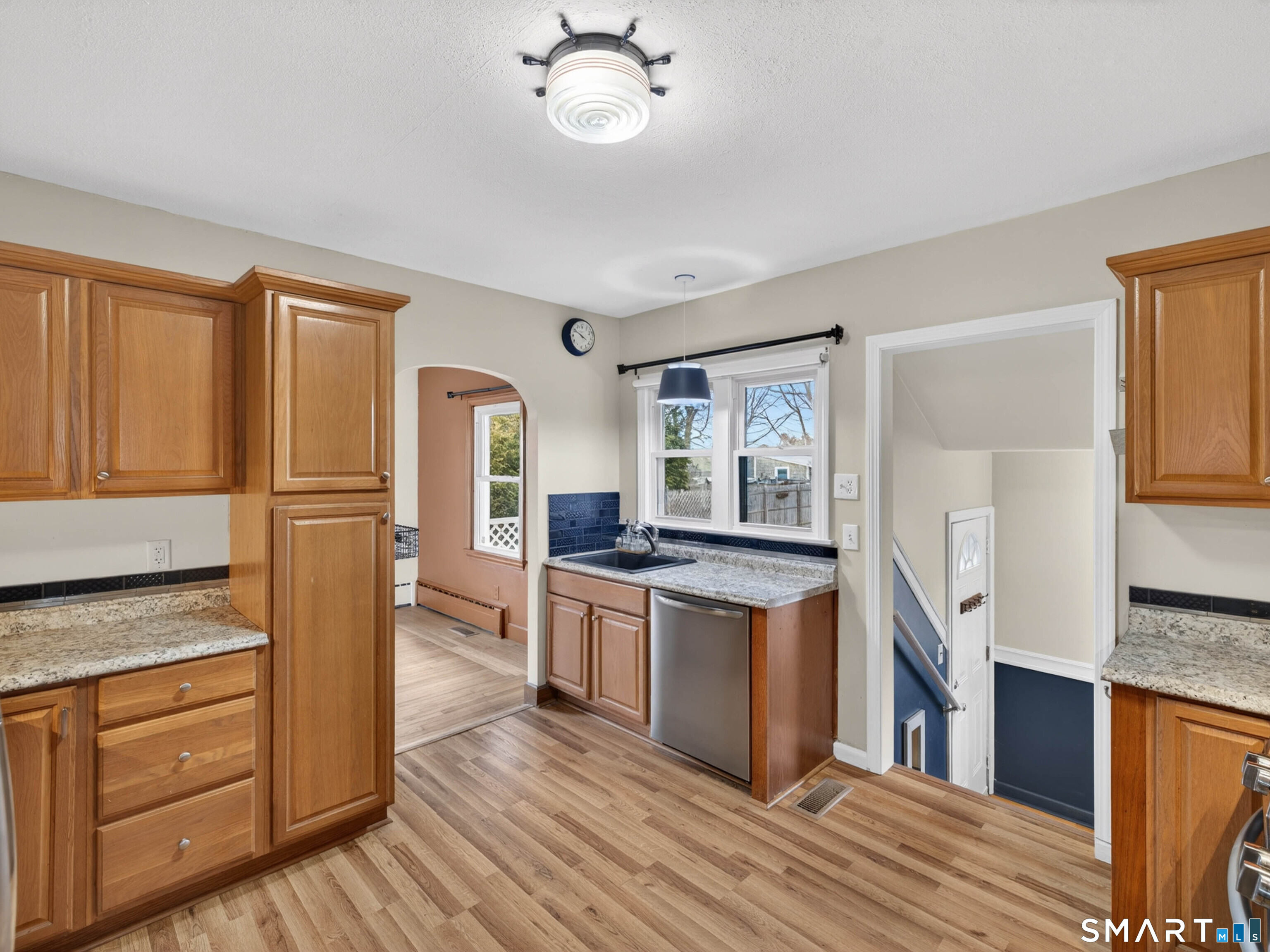 36 Baker Avenue Groton, CT 06340 - Photo 17 of 38 a kitchen with stainless steel appliances granite countertop a refrigerator a stove and a sink with wooden floor