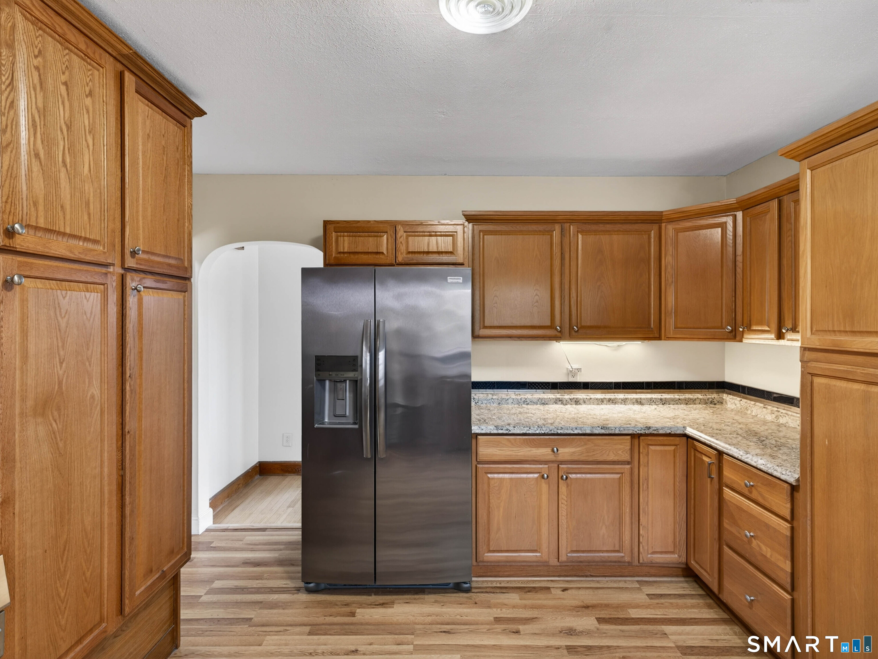 36 Baker Avenue Groton, CT 06340 - Photo 19 of 38 a kitchen with a refrigerator sink and cabinets