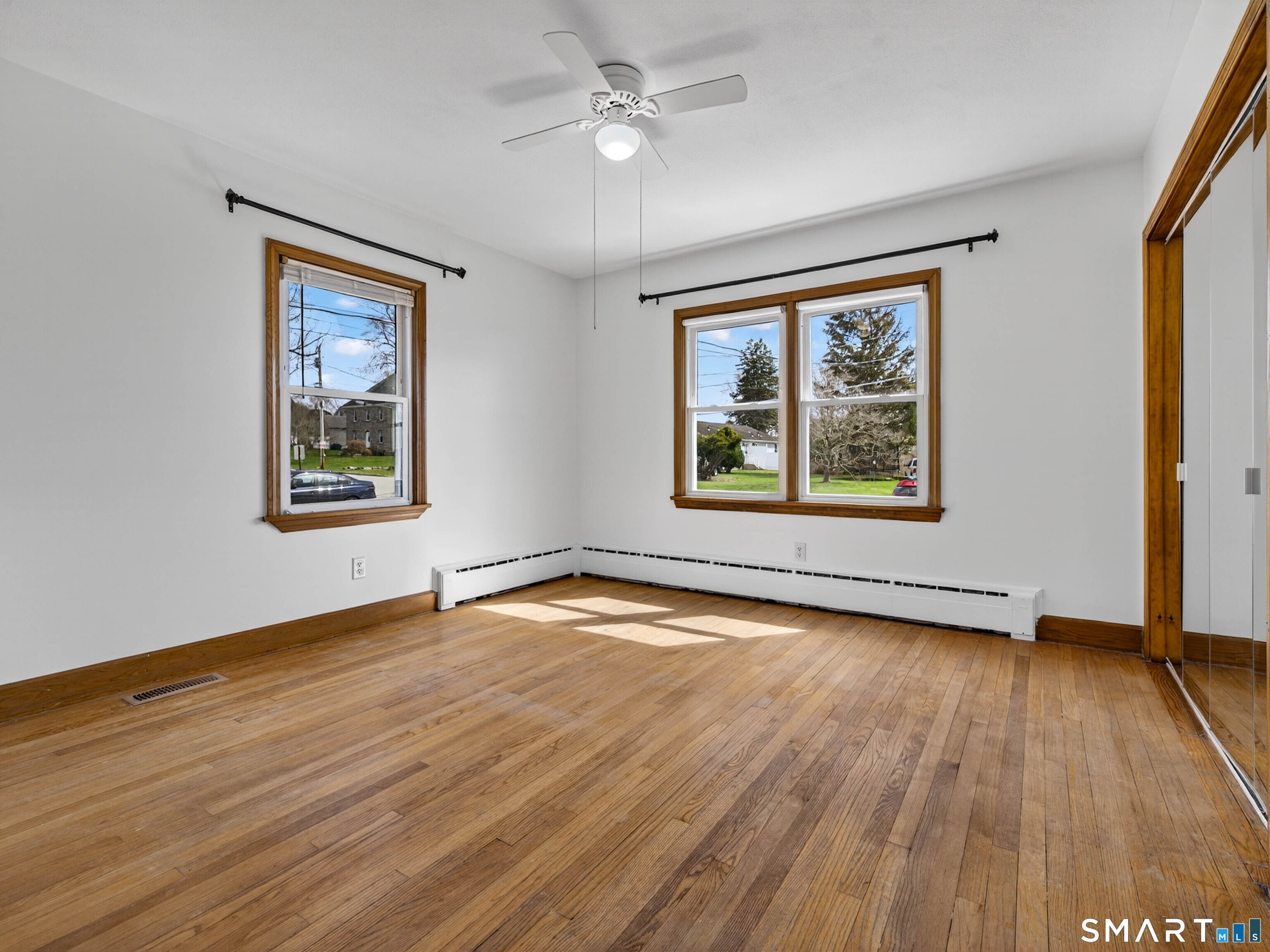 36 Baker Avenue Groton, CT 06340 - Photo 22 of 38 a view of an empty room with a window and wooden floor