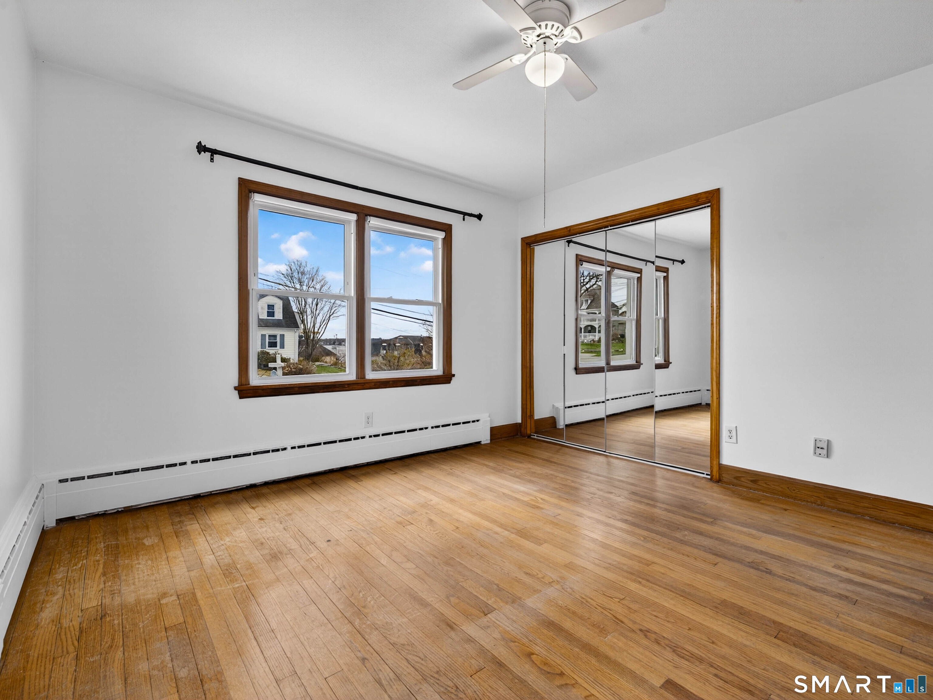 36 Baker Avenue Groton, CT 06340 - Photo 23 of 38 a view of an empty room with wooden floor and a window