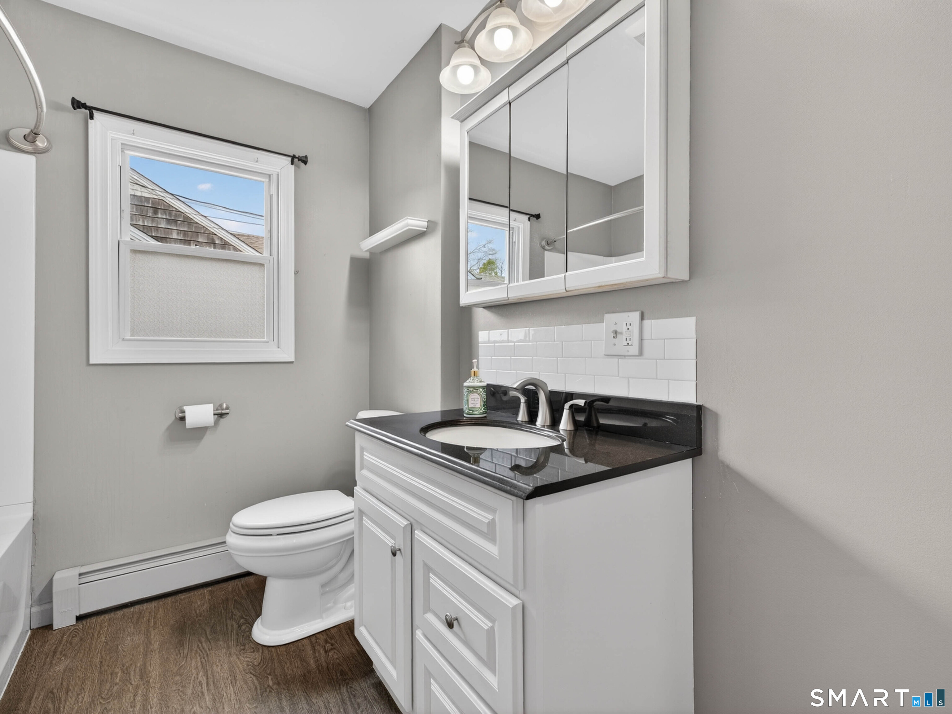 36 Baker Avenue Groton, CT 06340 - Photo 24 of 38 a bathroom with a granite countertop toilet sink and mirror