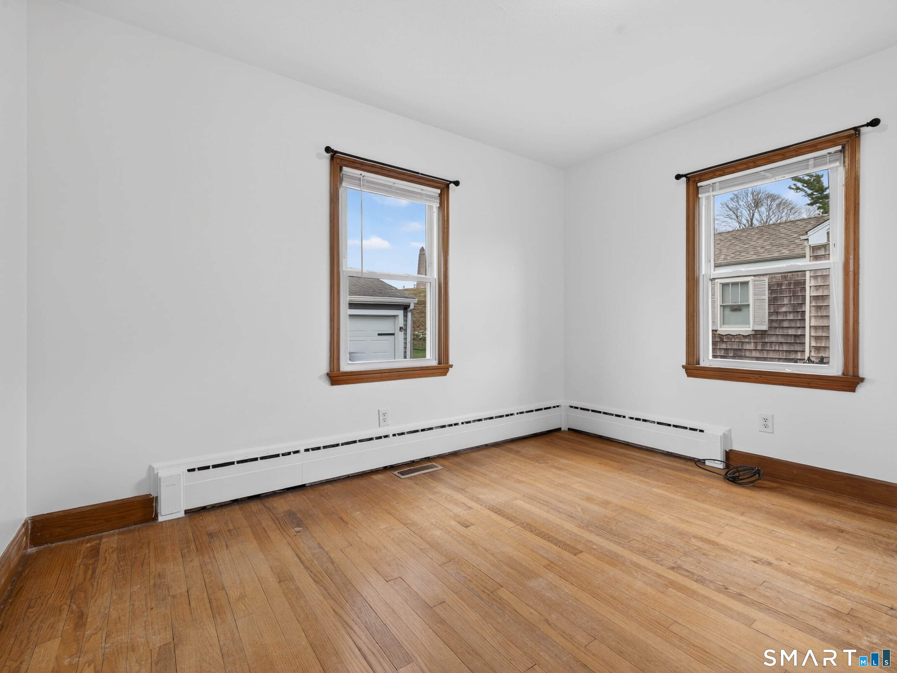 36 Baker Avenue Groton, CT 06340 - Photo 26 of 38 an empty room with wooden floor and windows