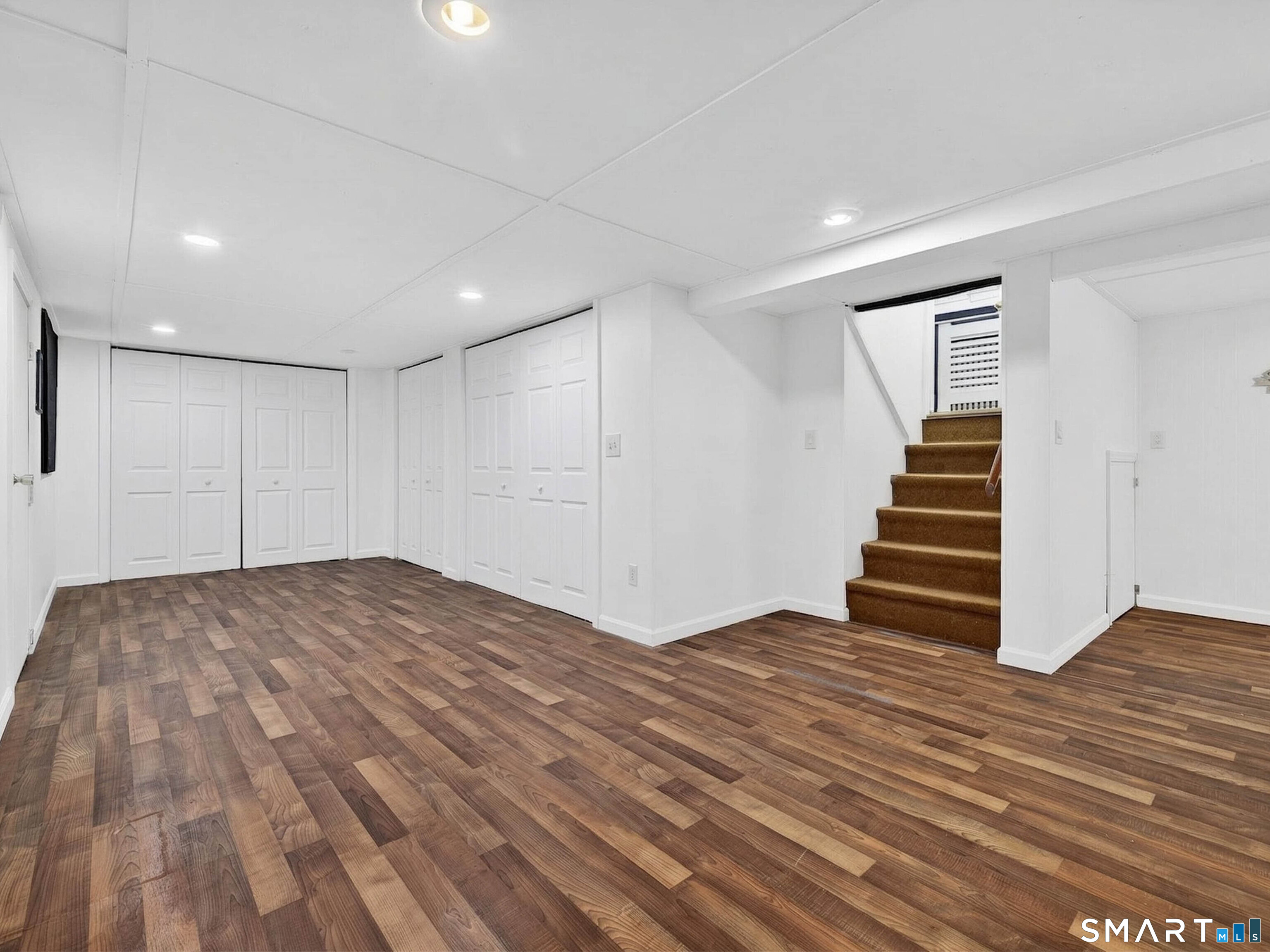36 Baker Avenue Groton, CT 06340 - Photo 33 of 38 a view of empty room with stairs and wooden floor