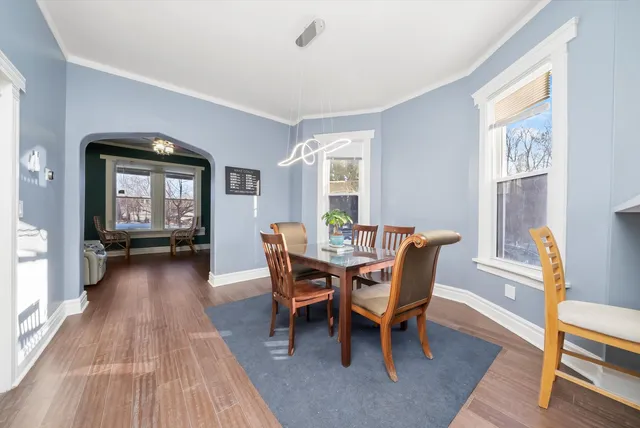a view of a dining room with furniture window and wooden floor