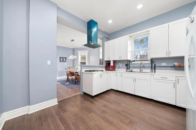 a kitchen with cabinets a sink and wooden floors