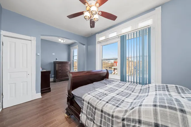 a bedroom with a large bed and a chandelier