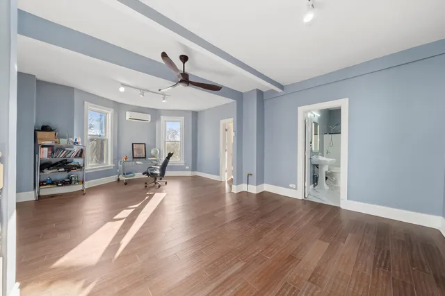 a view of a livingroom with hardwood floor and a ceiling fan