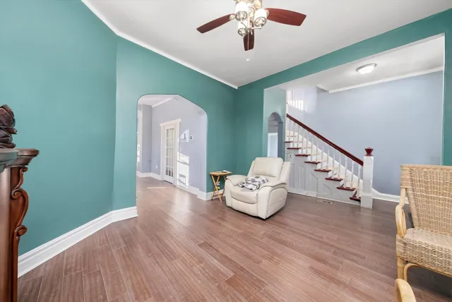 a living room with furniture and a chandelier