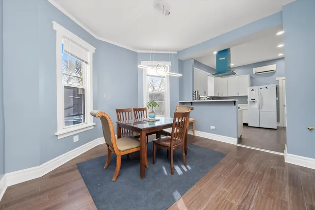 a dining room with furniture and wooden floor