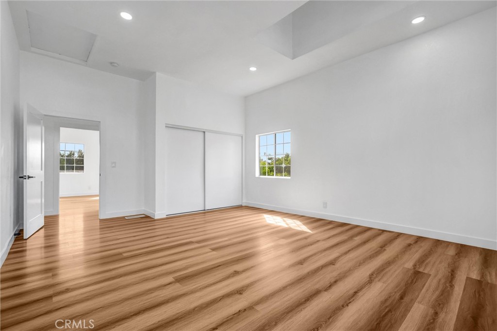 1200 South Castlegate Avenue Compton, CA 90221 - Photo 29 of 39 a view of an empty room with wooden floor and a window