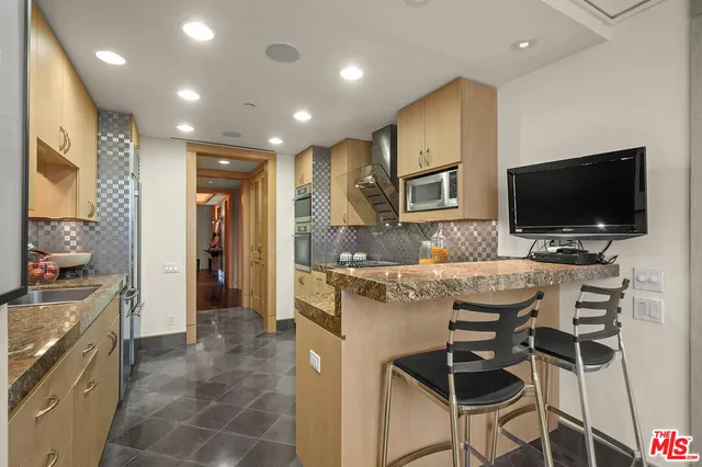 a kitchen with a sink stainless steel appliances and cabinets