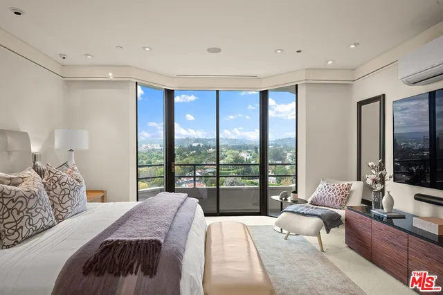 a bedroom with a large bed and a large window