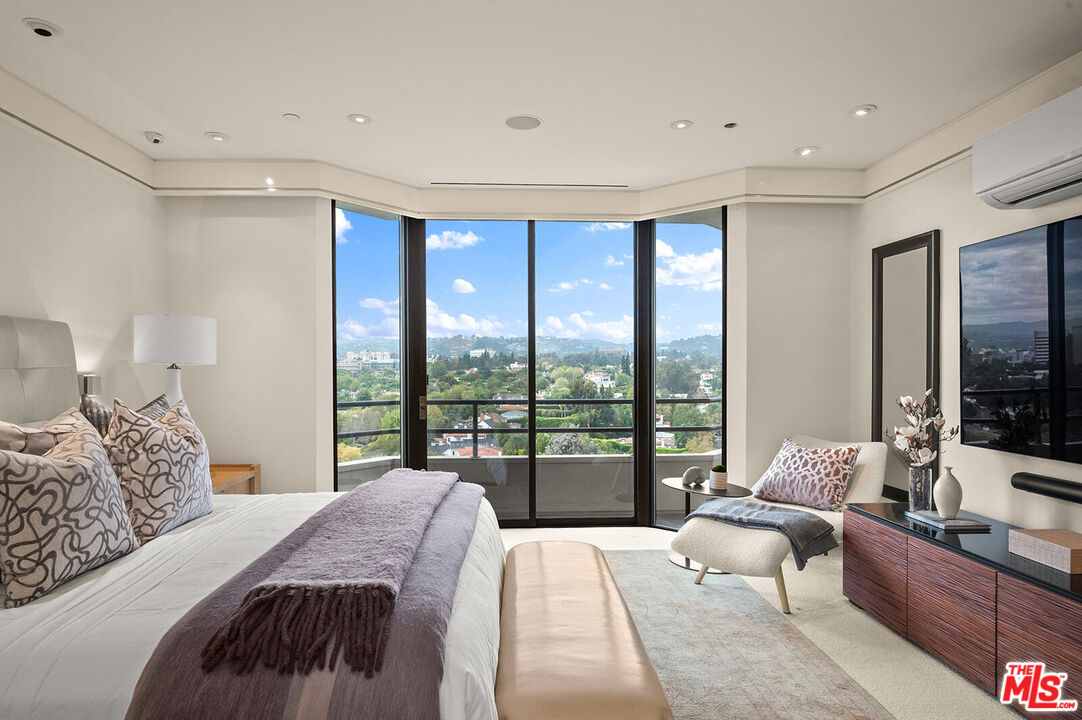 10601 Wilshire Boulevard, Unit 1201 Los Angeles, CA 90024 - Photo 18 of 48 a bedroom with a large bed and a large window