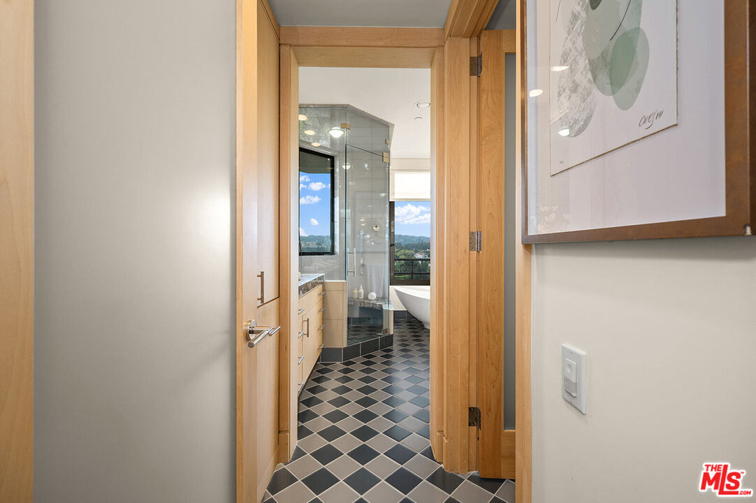 10601 Wilshire Boulevard, Unit 1201 Los Angeles, CA 90024 - Photo 19 of 48 a view of a hallway with wooden floor and a dining room