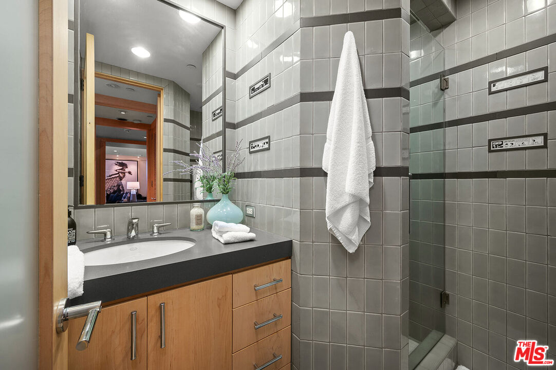 10601 Wilshire Boulevard, Unit 1201 Los Angeles, CA 90024 - Photo 29 of 48 a bathroom with a sink vanity and a mirror