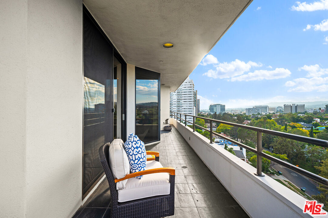 10601 Wilshire Boulevard, Unit 1201 Los Angeles, CA 90024 - Photo 30 of 48 a balcony with chairs and a table
