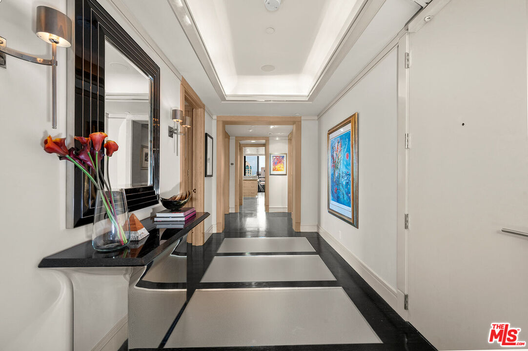 10601 Wilshire Boulevard, Unit 1201 Los Angeles, CA 90024 - Photo 3 of 48 a hallway with beautiful frames and flower vase