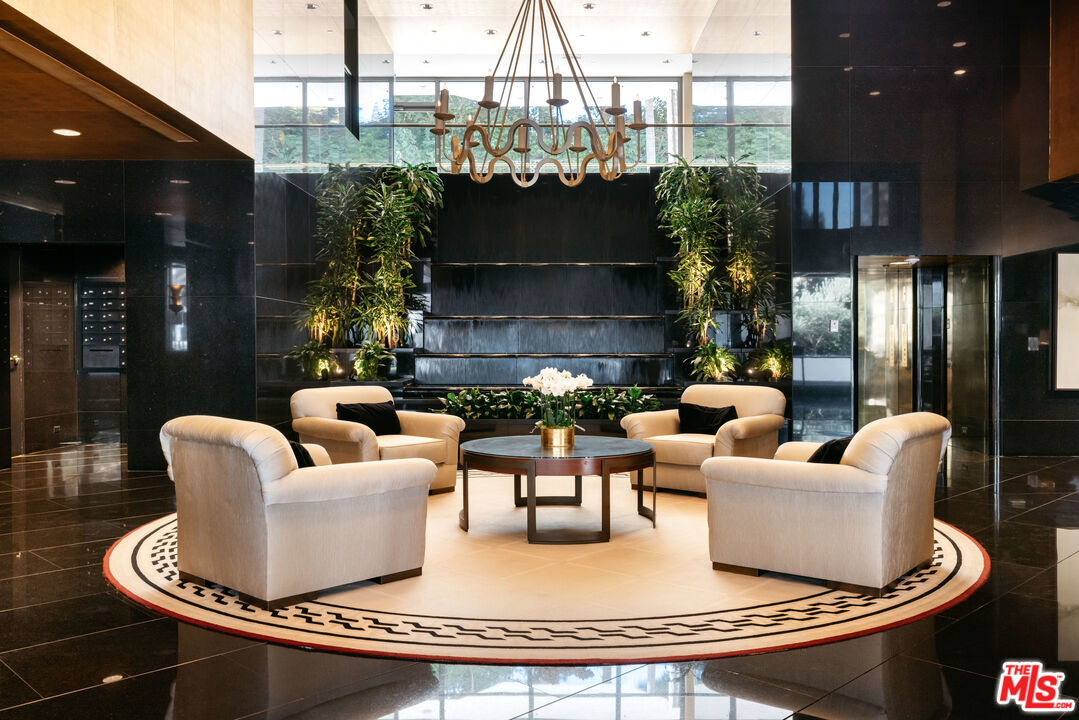 10601 Wilshire Boulevard, Unit 1201 Los Angeles, CA 90024 - Photo 37 of 48 a living room with furniture and a chandelier