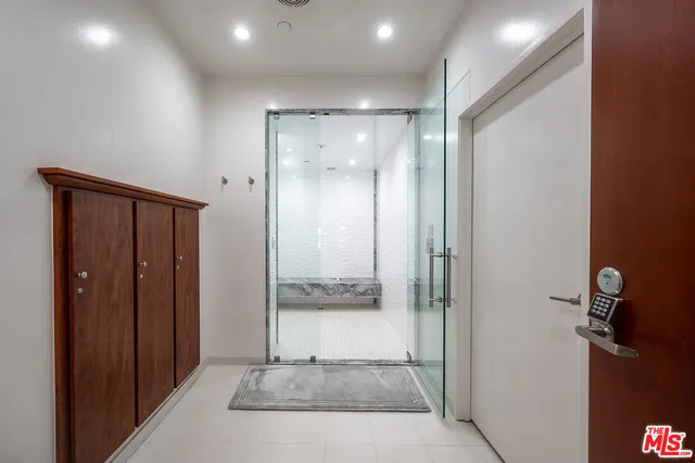 a view of a hallway with wooden shelves