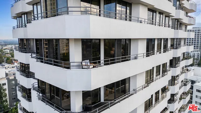 a view of a large building with large windows and a white roof