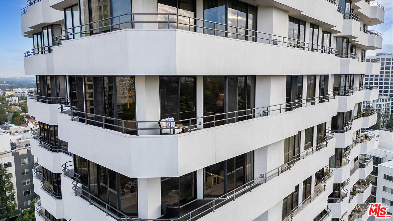 10601 Wilshire Boulevard, Unit 1201 Los Angeles, CA 90024 - Photo 47 of 48 a view of a large building with large windows and a white roof
