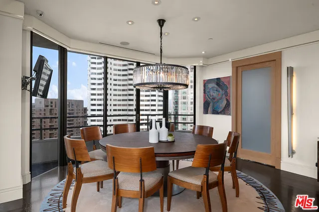 a dining room with furniture window and wooden floor