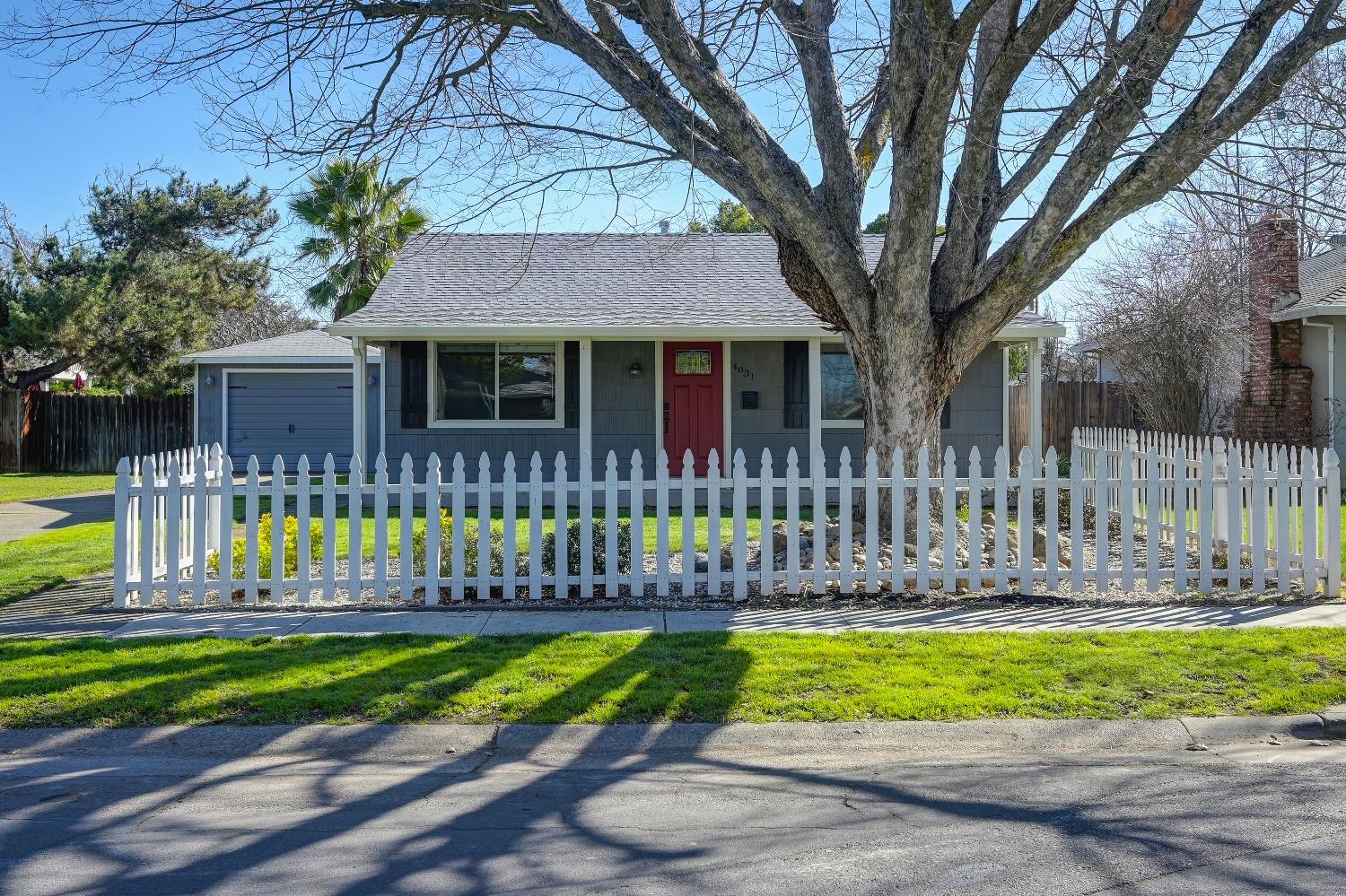 4031 67th Street Sacramento, CA 95820 - Photo 1 of 1 a front view of a house with a garden