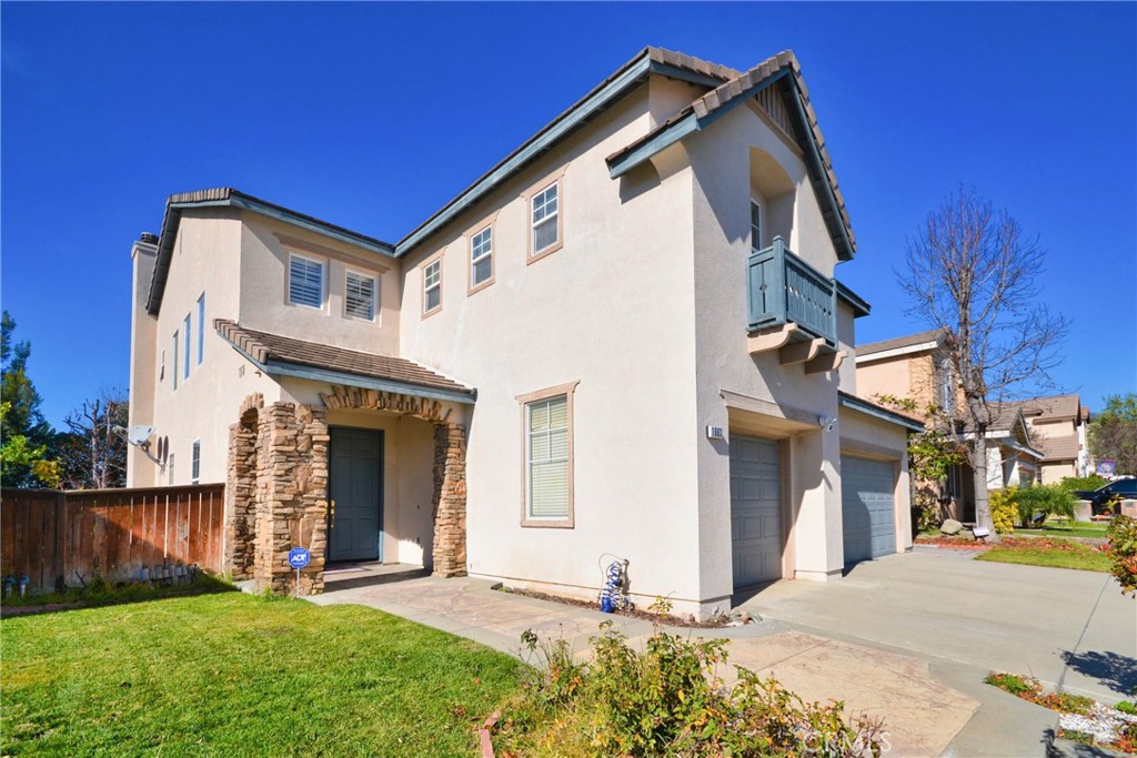 1663 North Rocky Road Upland, CA 91784 - Photo 1 of 1 a front view of a house with a yard and garage