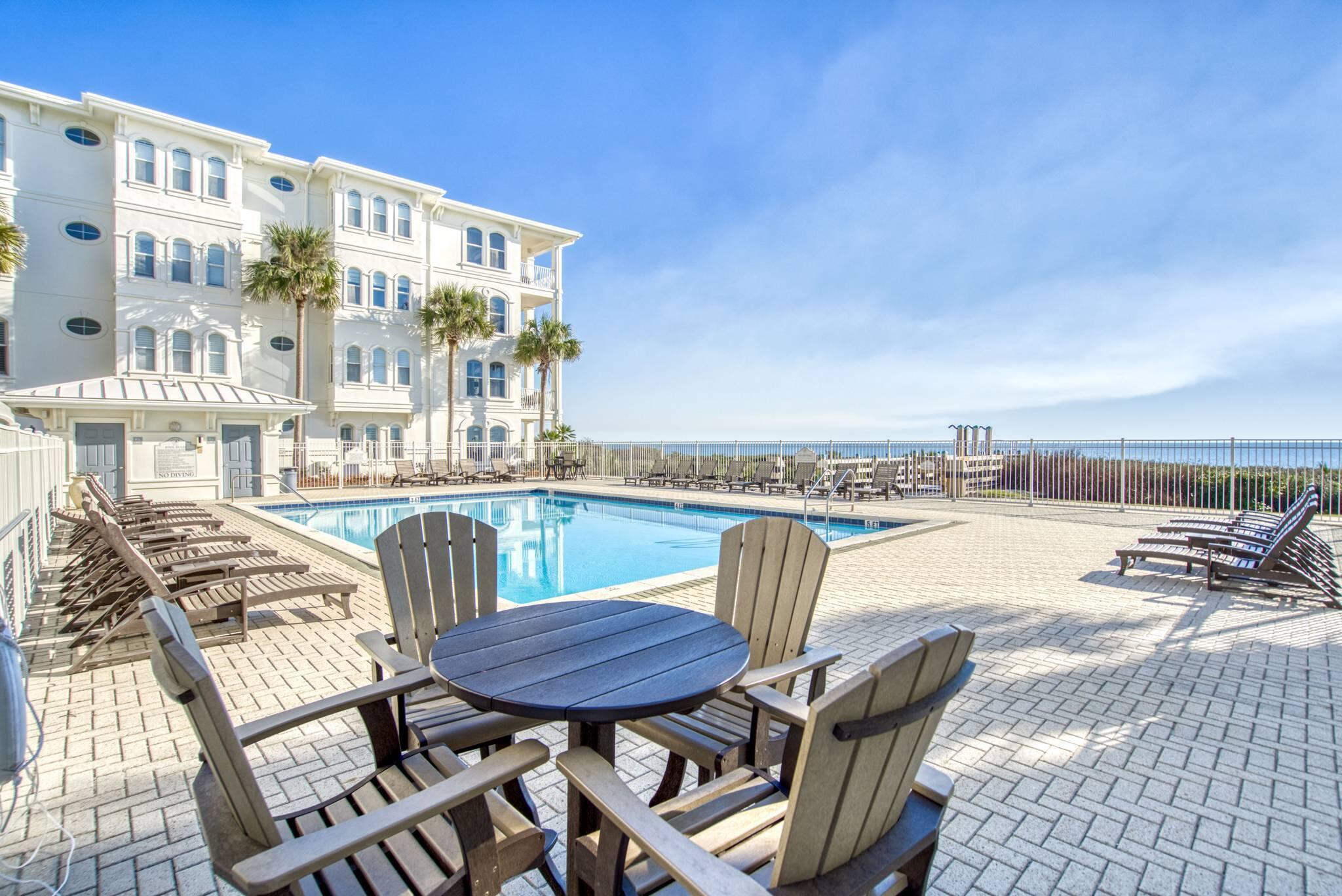 10140 East County Highway 30A, Unit 2 Inlet Beach, FL 32461 - Photo 61 of 92 a view of a balcony with table and chairs