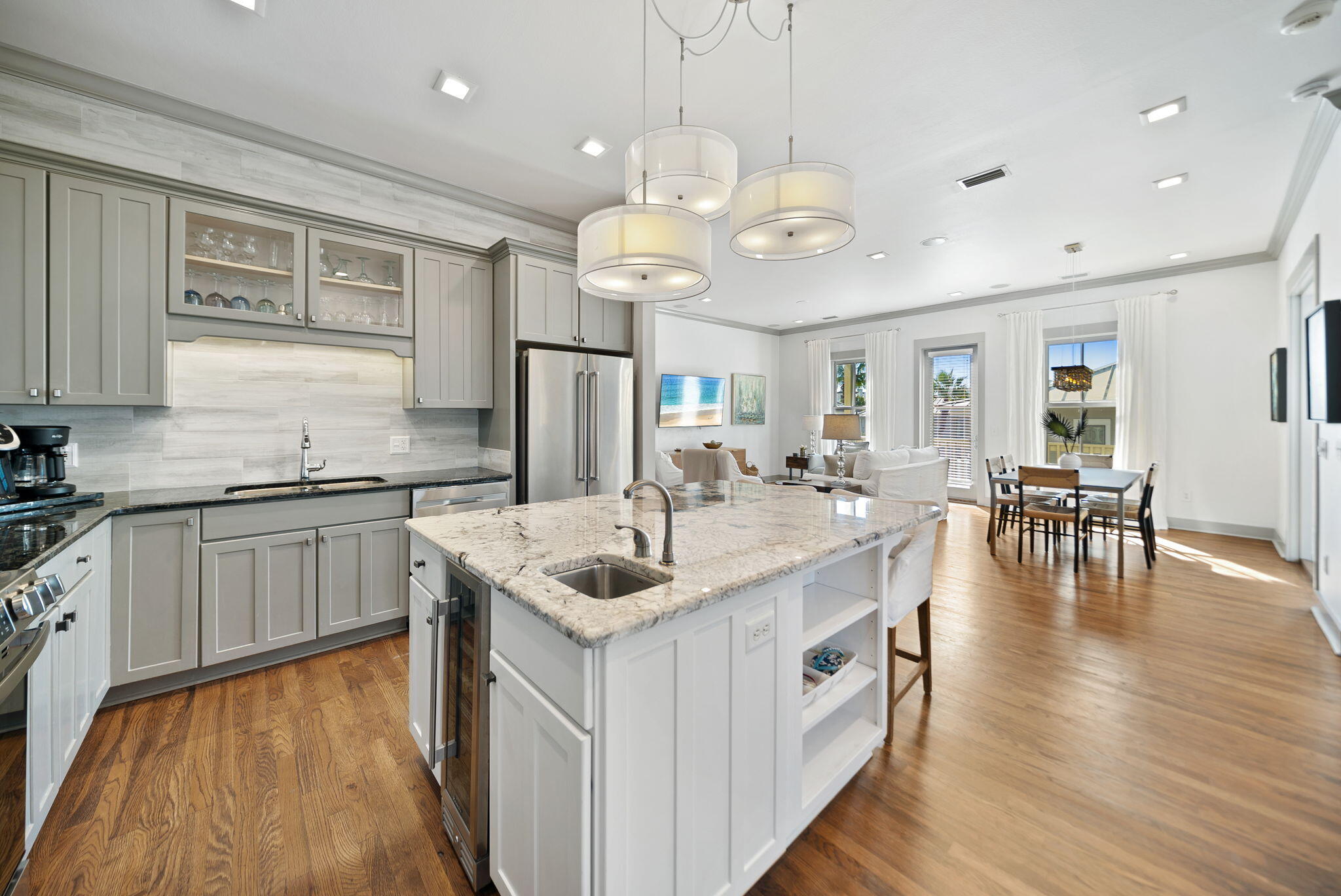 10140 East County Highway 30A, Unit 2 Inlet Beach, FL 32461 - Photo 8 of 92 a kitchen with stainless steel appliances granite countertop a sink a stove top oven a counter space and wooden floor