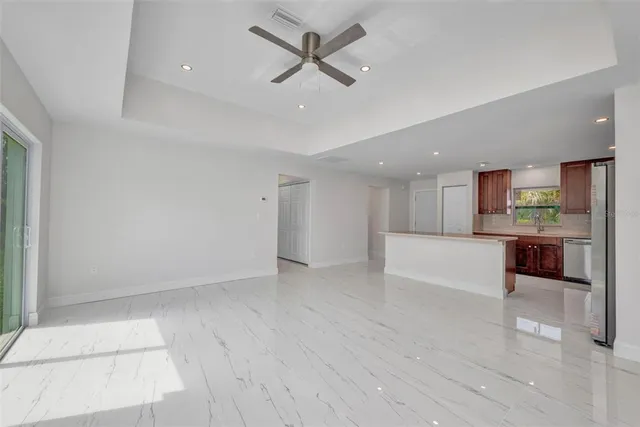 a view of a room with wooden floor and windows