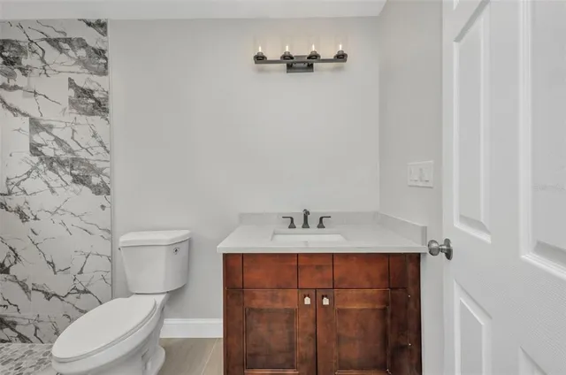 a bathroom with a toilet and a shower curtain
