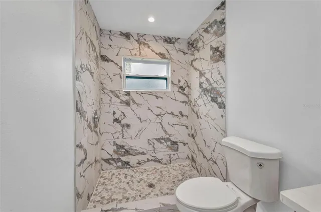 a bathroom with a sink toilet and shower