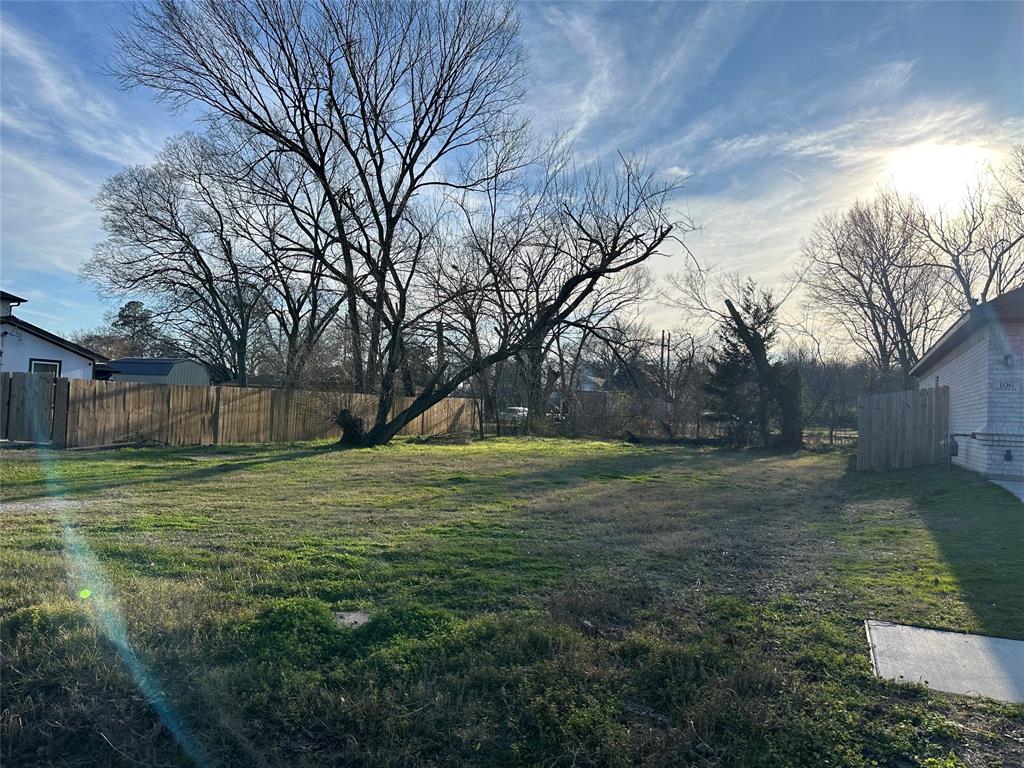 104 Boone Street Terrell, TX 75160 - Photo 2 of 4 a view of a trees in a yard