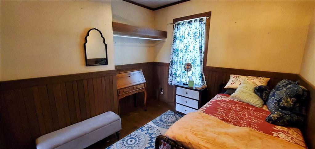115 Country Club Road Butler, PA 16002 - Photo 16 of 50 a bed sitting in a bedroom next to a window with potted plants
