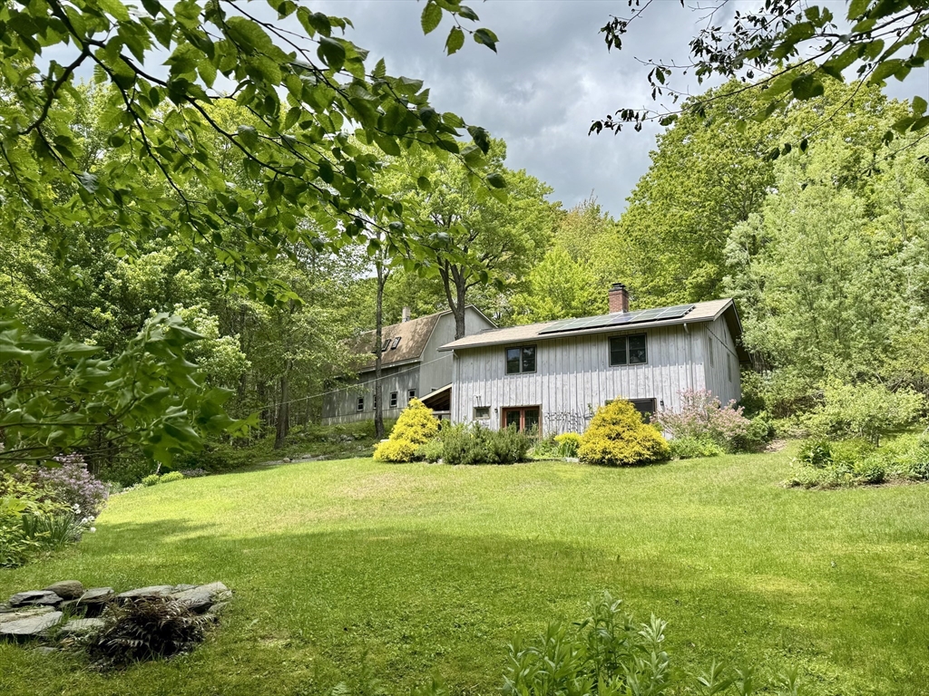 1450 W Road Ashfield, MA 01330 - Photo 1 of 36 a front view of house with yard and green space